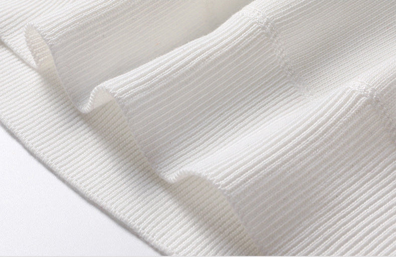 Close-up of ribbed knit texture on men's white turtleneck pullover sweater - fine fabric weave detail