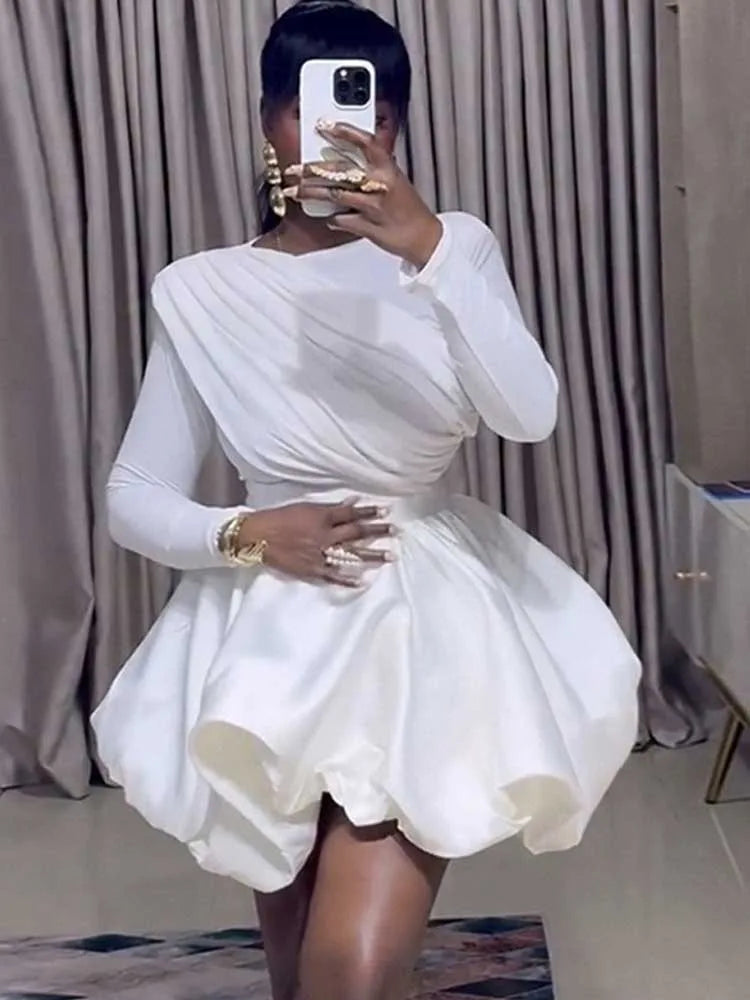 White puff sleeve bubble hem mini dress, close-up styling detail