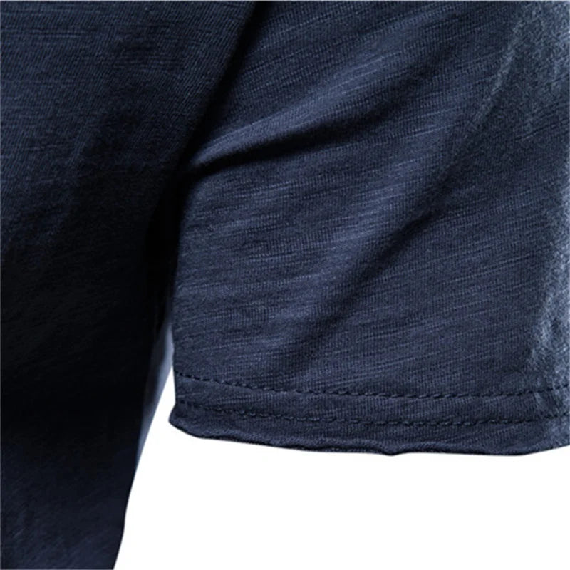 Close-up of men's 100% cotton O-neck t-shirt in navy blue showing hem stitching and fabric texture detail
