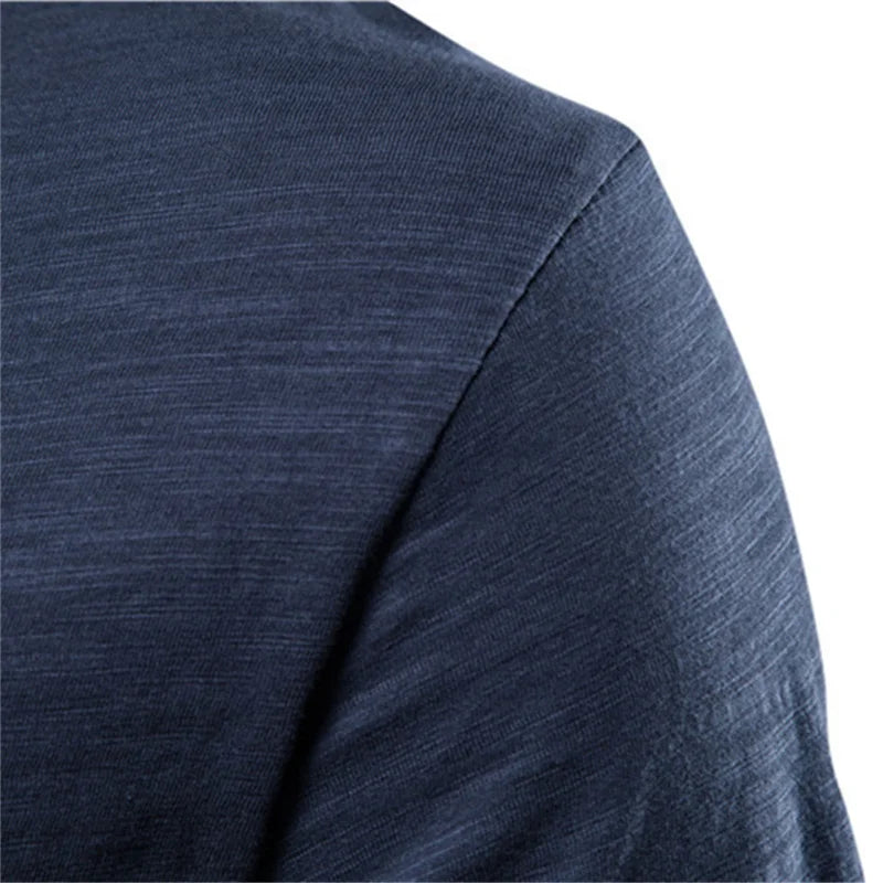 Close-up of men's 100% cotton O-neck t-shirt in navy blue showing shoulder and sleeve seam construction detail