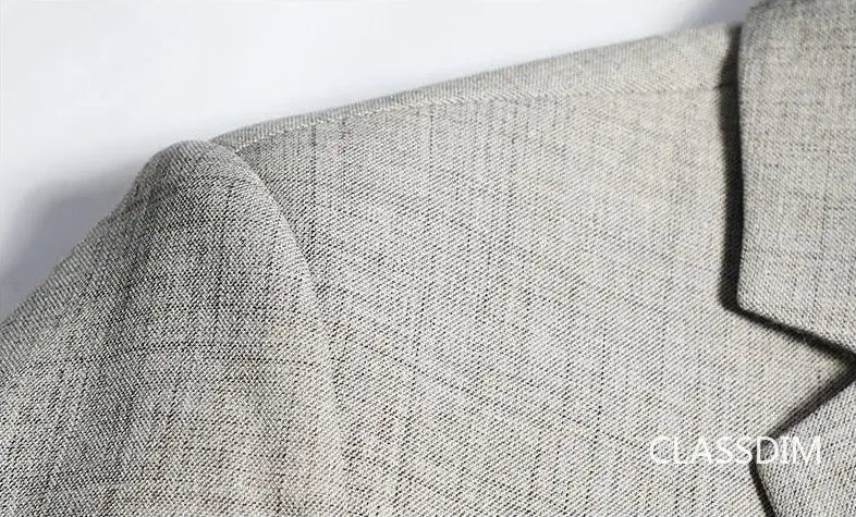 Men's slim fit blazer, beige cotton-polyester fabric texture and shoulder seam, close-up