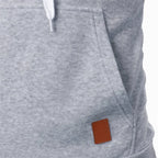 Closeup of kangaroo pocket with brown leather patch on men's lightweight light gray drawstring pullover hoodie