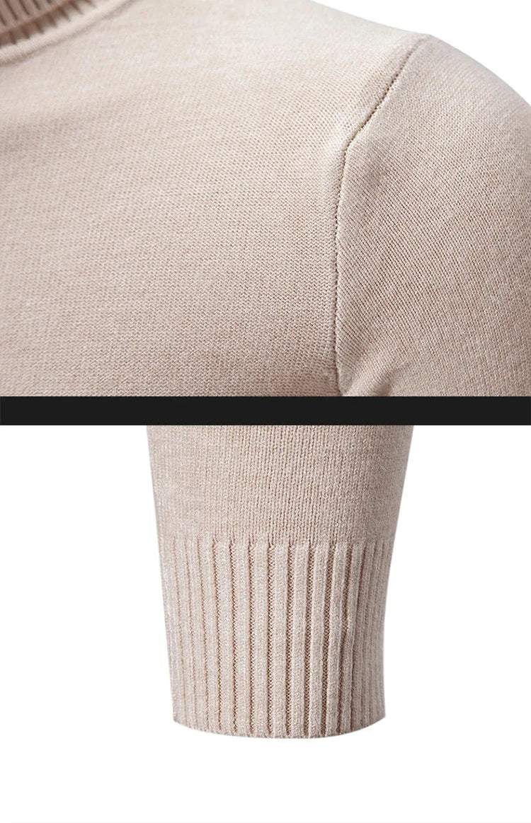 Men's oversized mock neck sweater in beige, close-up detail of shoulder seam and ribbed cuff