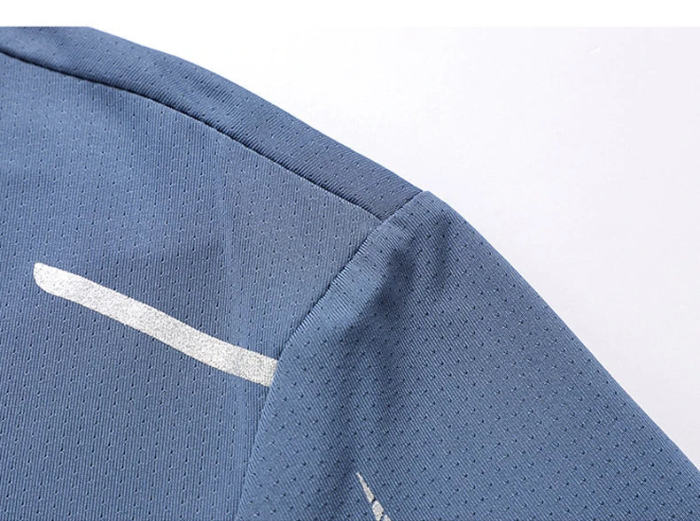 Close-up of athletic t-shirt breathable mesh fabric texture with reflective stripe on shoulder