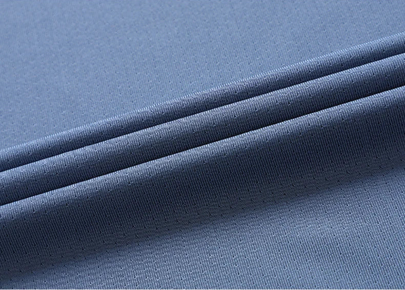 Close-up of athletic t-shirt breathable mesh fabric texture and stitching detail