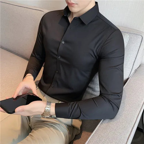 Men's slim fit dress shirt in black broadcloth long sleeve business shirt - front view sitting casual lifestyle