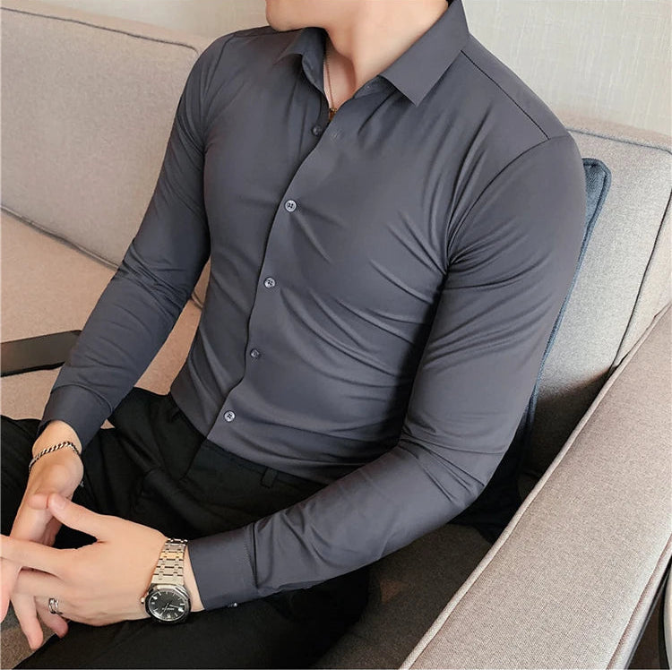 Men's slim fit dress shirt in charcoal gray broadcloth long sleeve business shirt - front view sitting pose