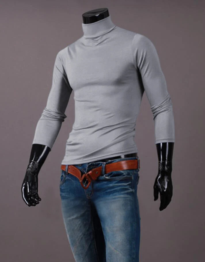 Men's thermal base layer turtleneck long sleeve top, light gray, styled on mannequin with jeans and belt, front view