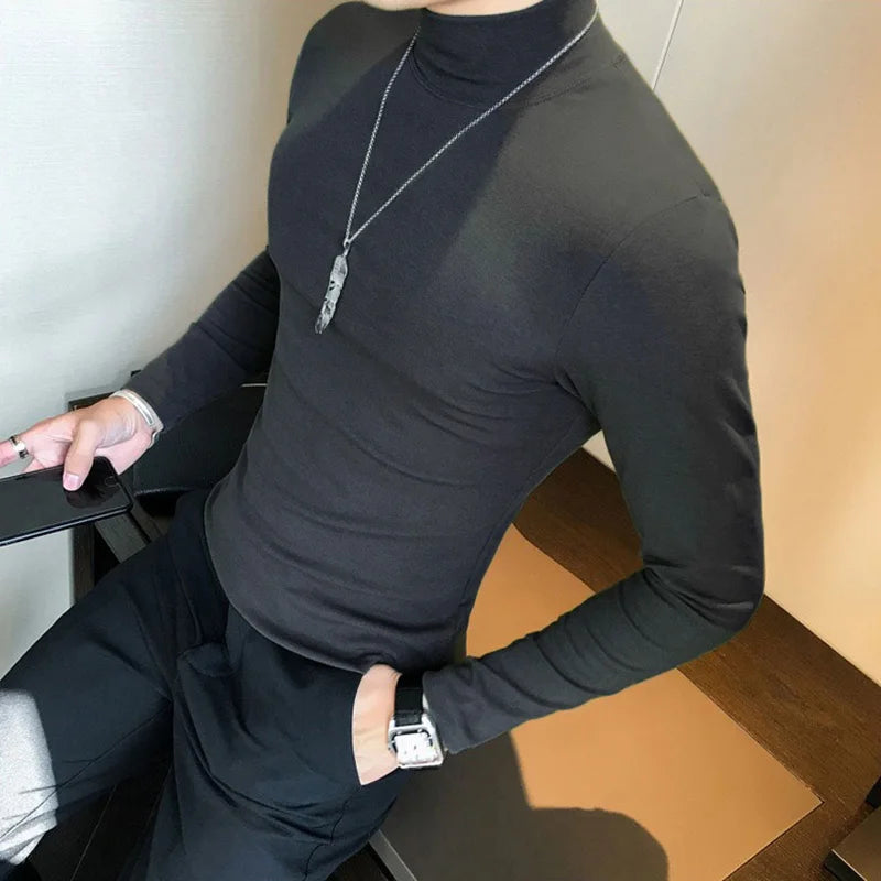 Men's turtleneck long sleeve shirt in black - slim fit high elastic cotton pullover, side view styled on model with dark pants