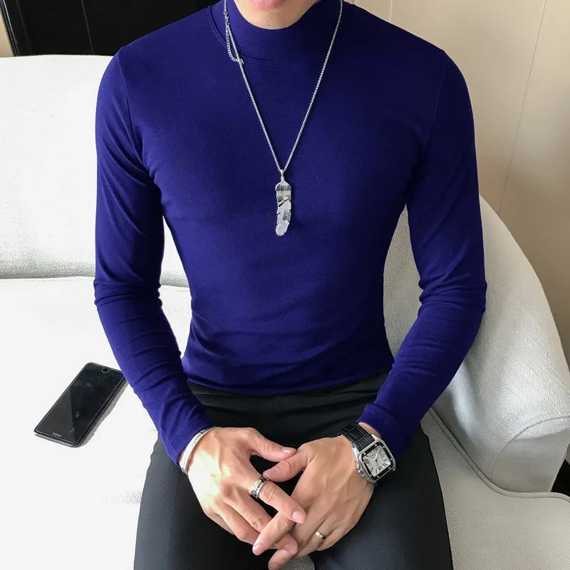 Men's turtleneck long sleeve shirt in navy blue - slim fit high elastic cotton pullover, front view styled on model seated with dark pants