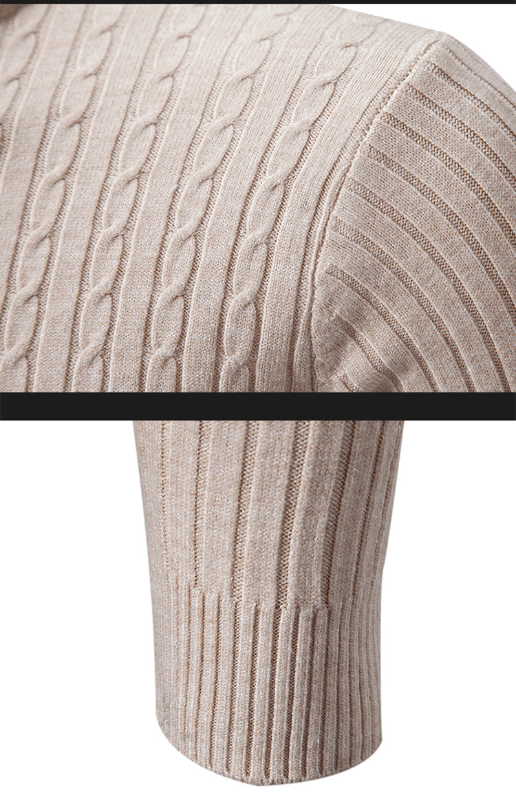 Close-up detail of beige cable knit turtleneck sweater showing shoulder and hem texture