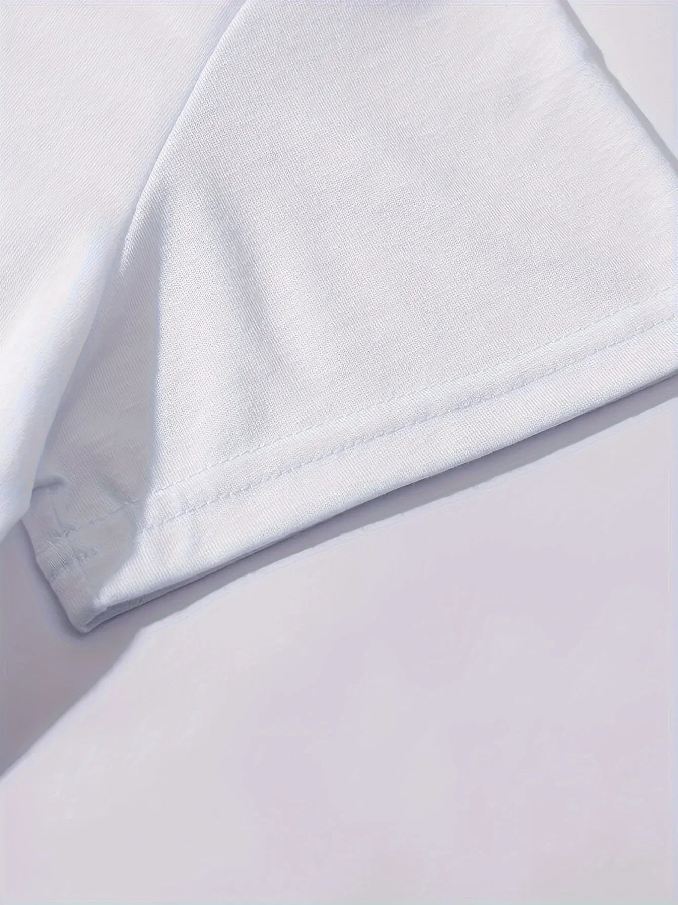 Close-up of white polyester fabric and crew neck detail on women's Paris graphic tee, soft lightweight material