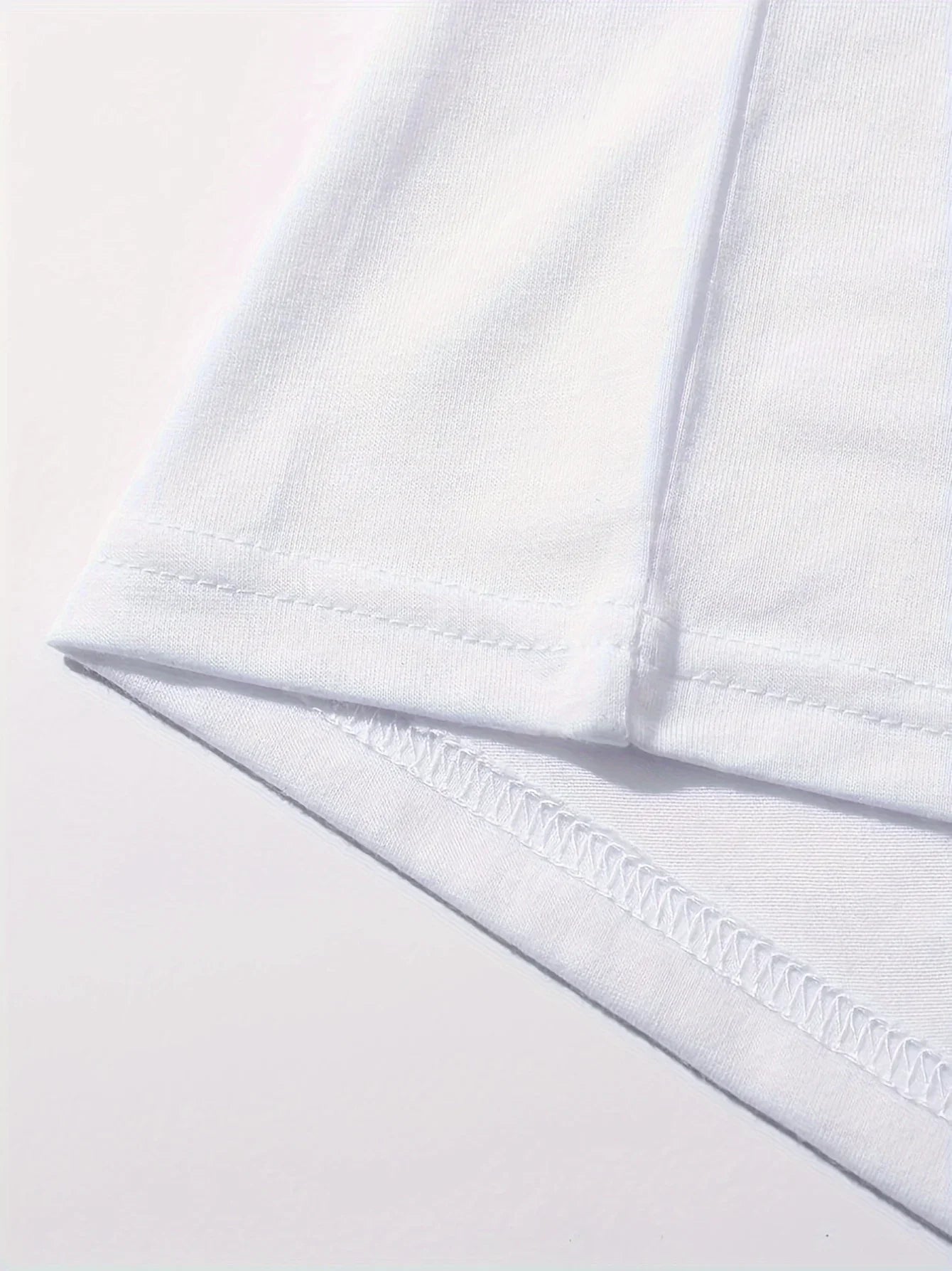Close-up of white polyester t-shirt hem and stitching detail, durable seam finish on women's Paris graphic tee