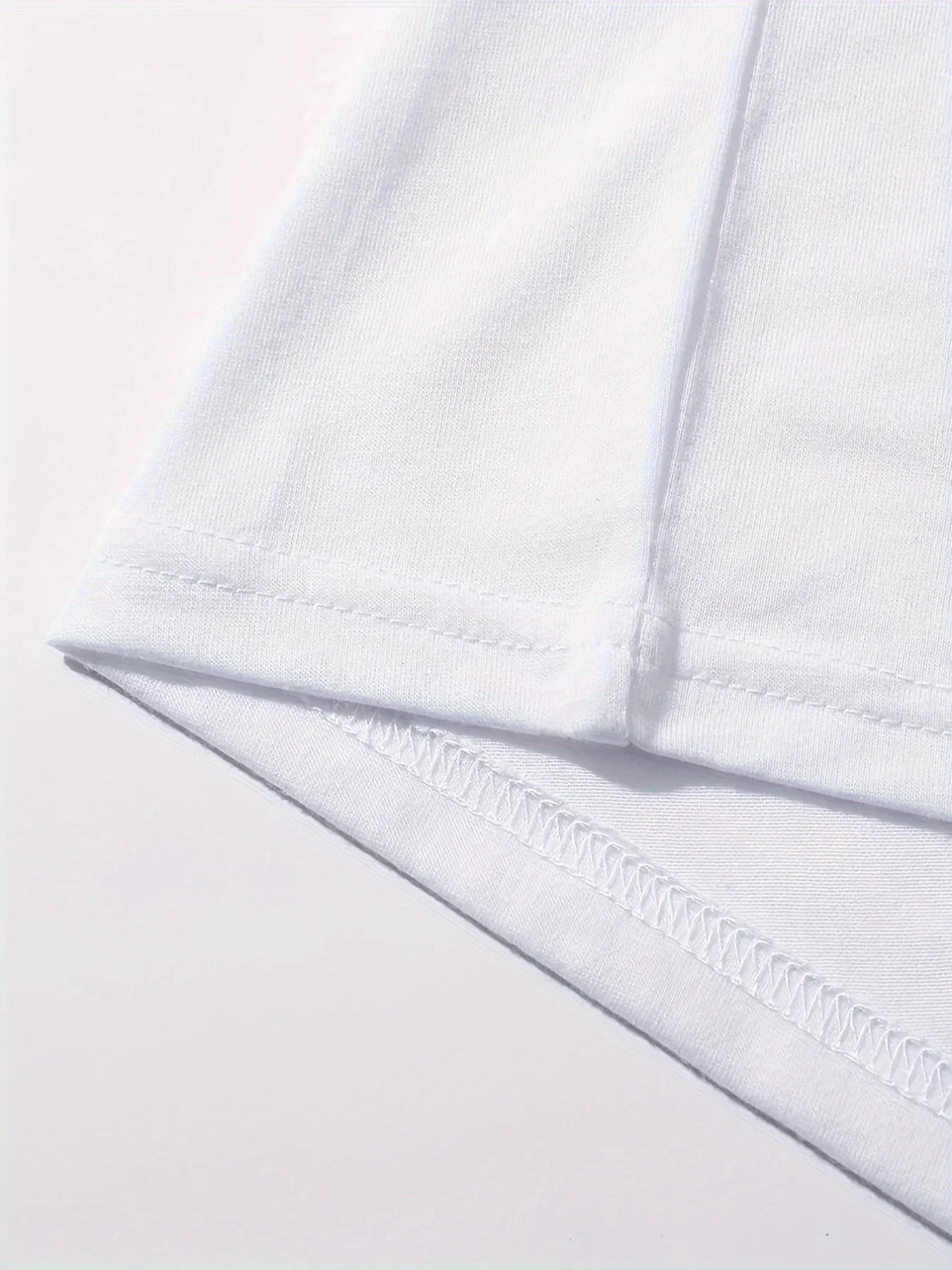 Close-up of white polyester t-shirt hem and stitching detail, durable seam finish on women's Paris graphic tee