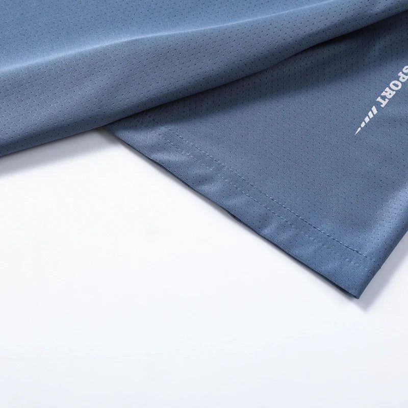 Close-up detail of CHRLCK Men's Quick Dry Running T-Shirt reflective stripe on sleeve hem