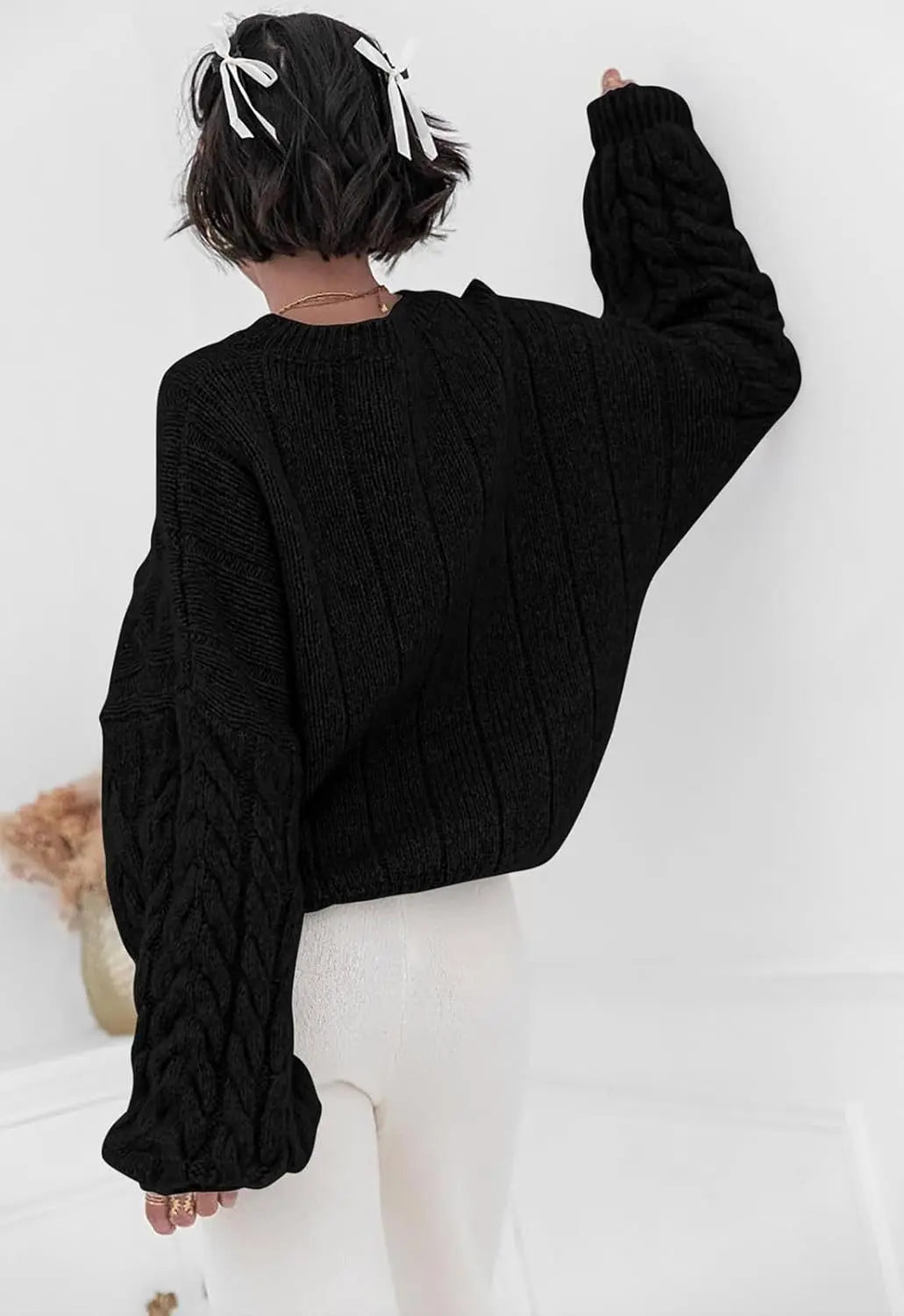 Women's black O-neck knitted sweater back view cable knit pattern loose fit winter 2025