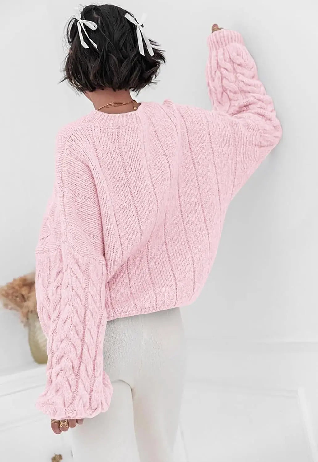 Women's pink O-neck knitted sweater back view cable knit pattern loose fit winter 2025