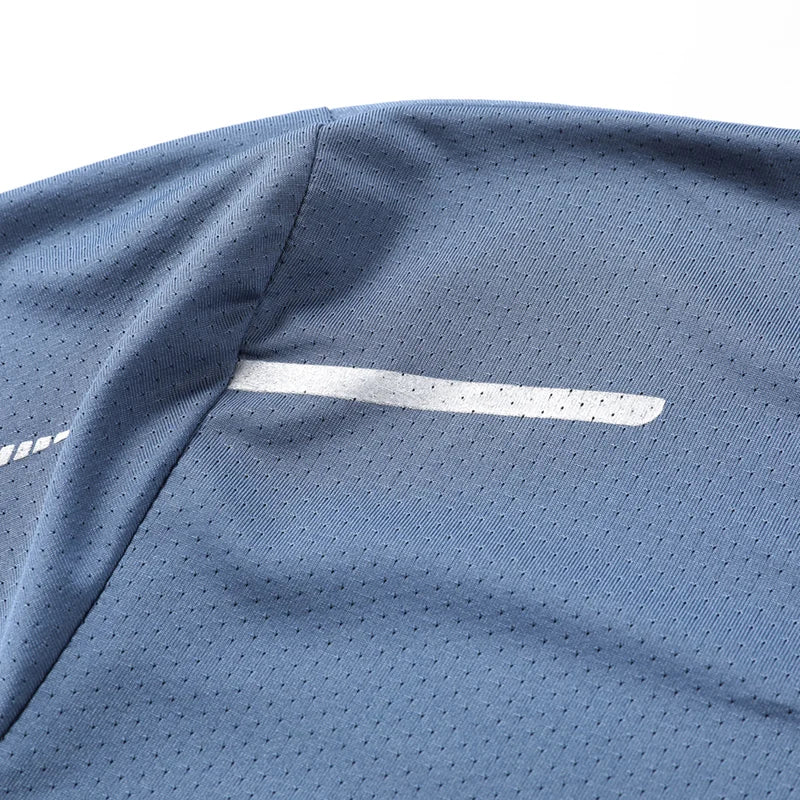 Close-up detail of CHRLCK Men's Quick Dry Running T-Shirt reflective stripe on chest and breathable fabric texture