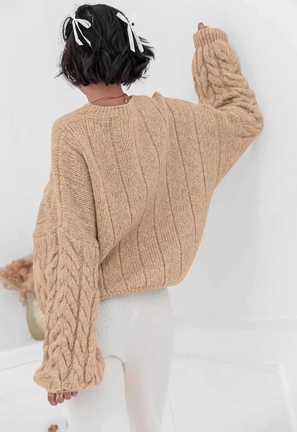 Women's beige O-neck knitted sweater back view cable knit pattern loose fit winter 2025