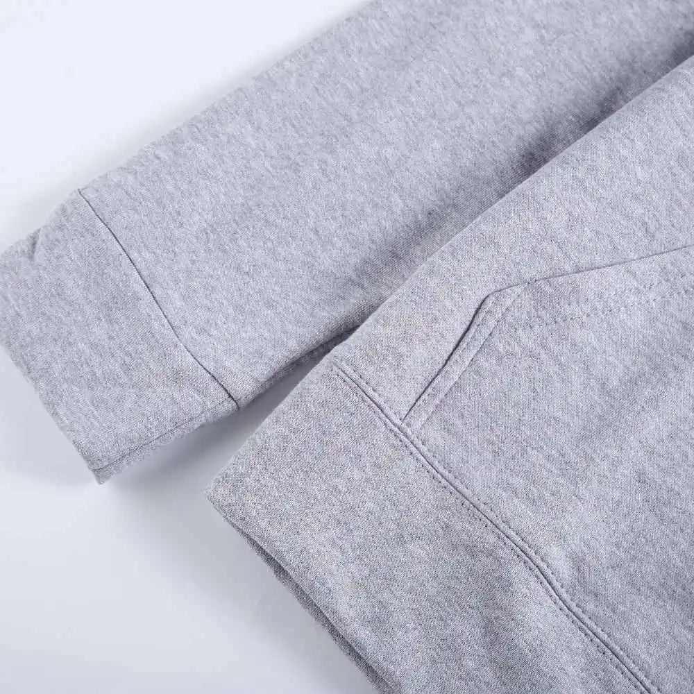 Close-up of gray Rindu sport pants showing stitching detail and fleece fabric texture