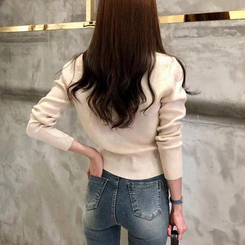 Cream women's autumn cardigan long sleeve knitted sweater back view with ribbed waistband