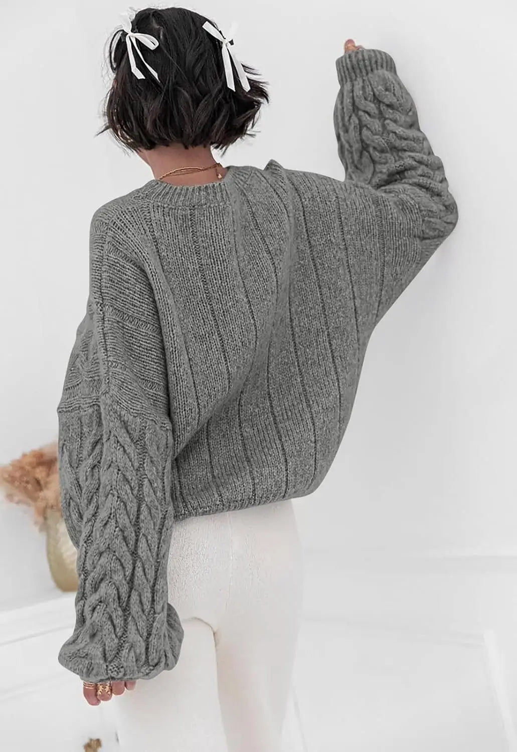 Women's gray O-neck knitted sweater back view cable knit pattern loose fit winter 2025
