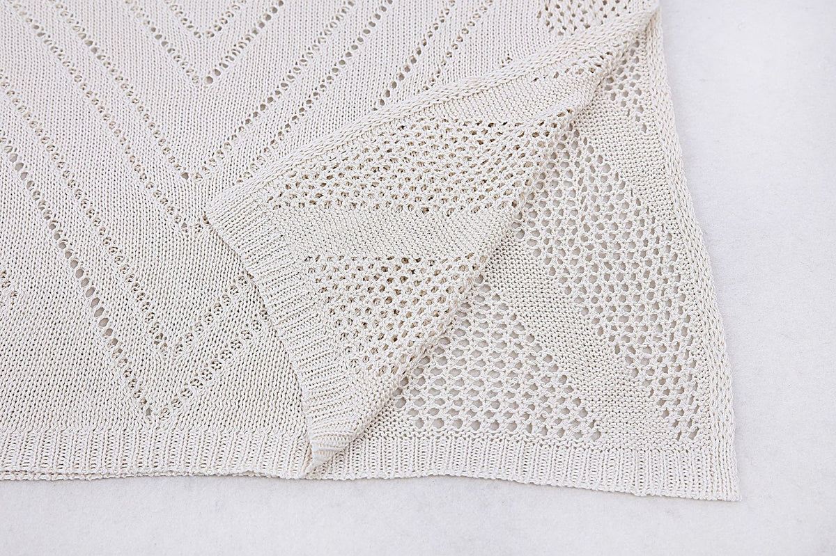 Close-up of open-knit fabric with chevron and geometric pattern detail on the women's backless maxi dress