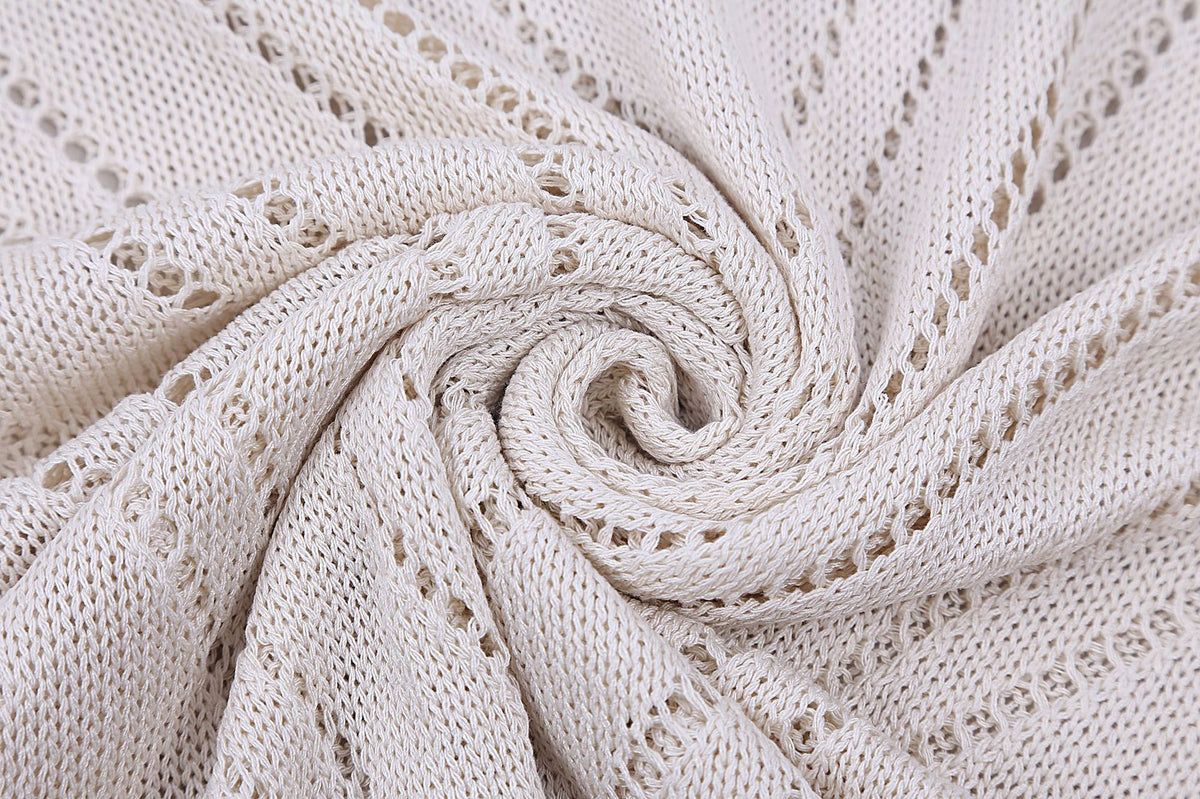 Close-up of open-knit fabric texture with spiral pattern used in the women's backless maxi dress