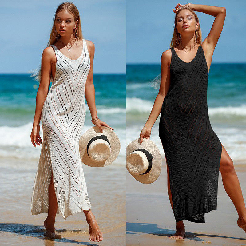 Women's backless knit maxi dress in white and black, front view on beach