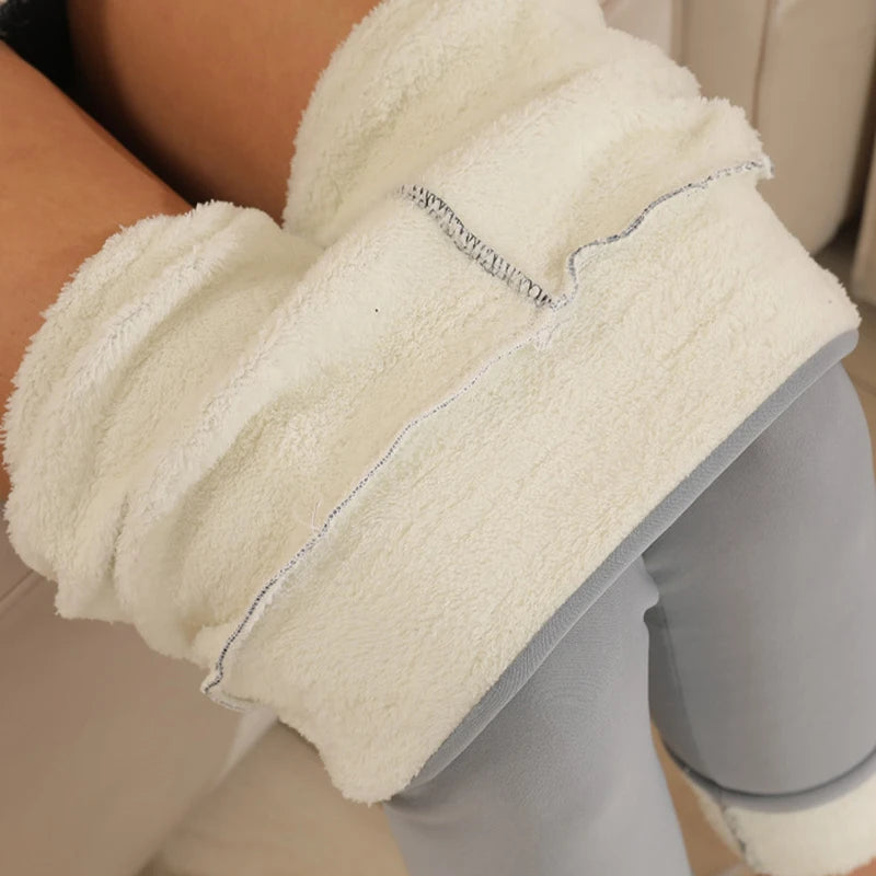 Women's high waist fleece lined thermal leggings in light gray, extreme close-up of ultra thick plush cream fleece interior lining texture and seam detail