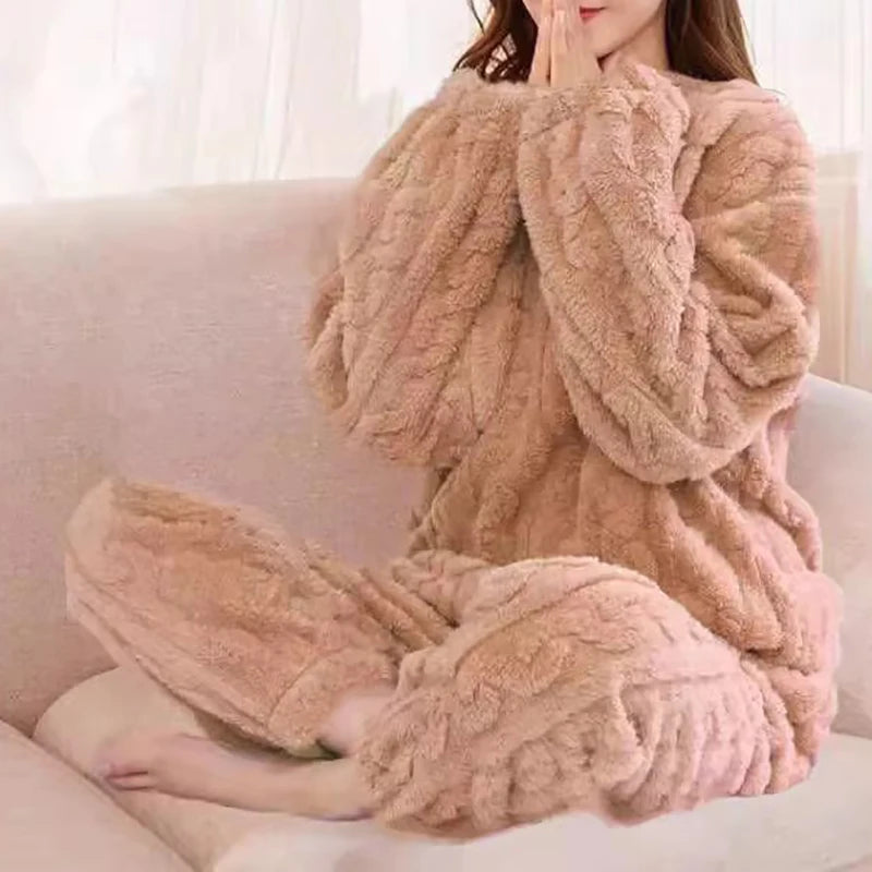 Women's fleece pajama set in beige with textured ruffle detail - long sleeve top and elastic waist pants, styled on model seated on sofa, front view