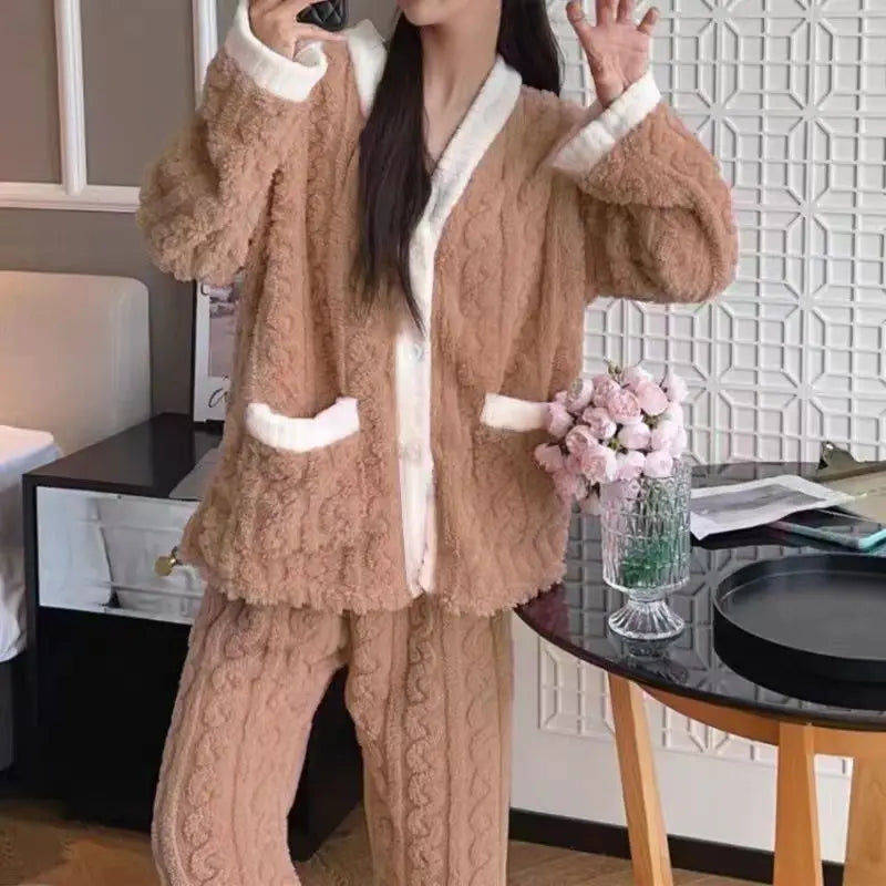 Women's fleece pajama set in camel brown with white sherpa trim and front pockets - long sleeve jacket top and elastic waist pants, styled on model in kitchen setting, front view