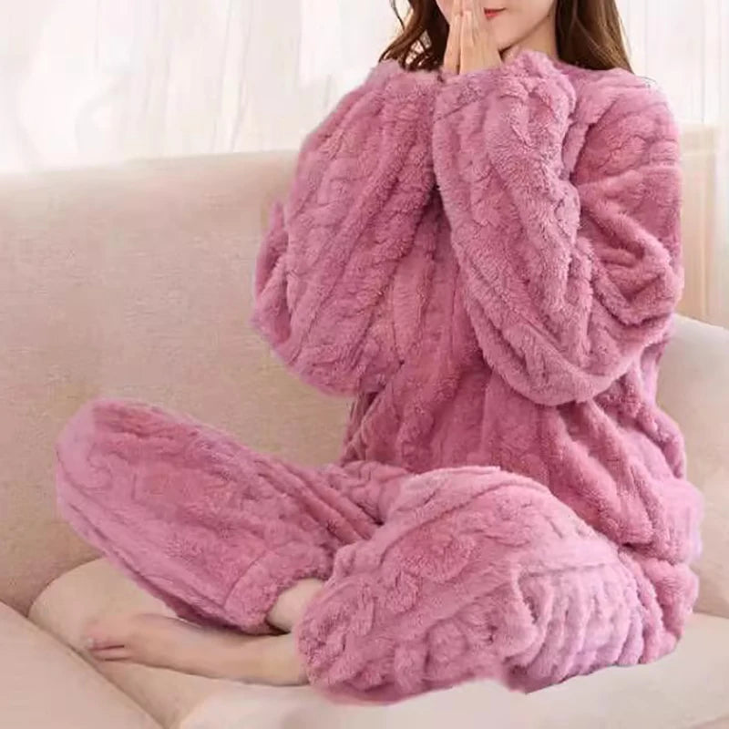 Women's fleece pajama set in mauve pink with textured ruffle detail - long sleeve top and elastic waist pants, styled on model seated on sofa, front view