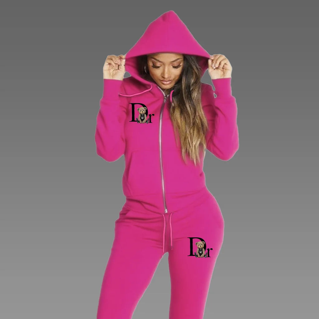 Woman wearing hot pink zip-up hoodie tracksuit set with matching sport pants, front view