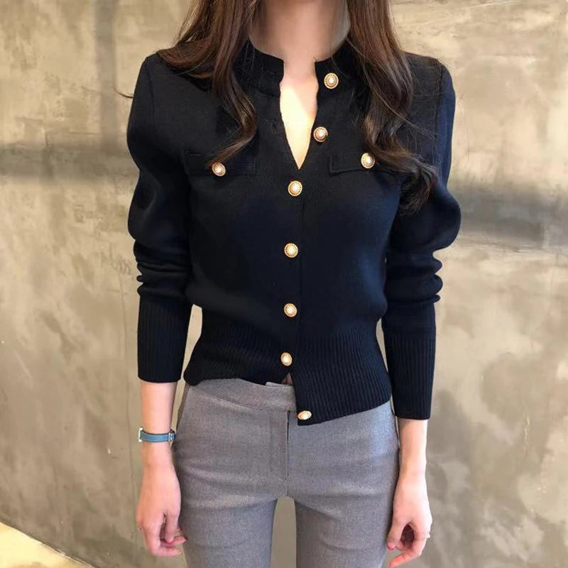 Women's knitted cardigan in black with gold button closure - long sleeve button-front sweater coat, full body front view styled with gray pants