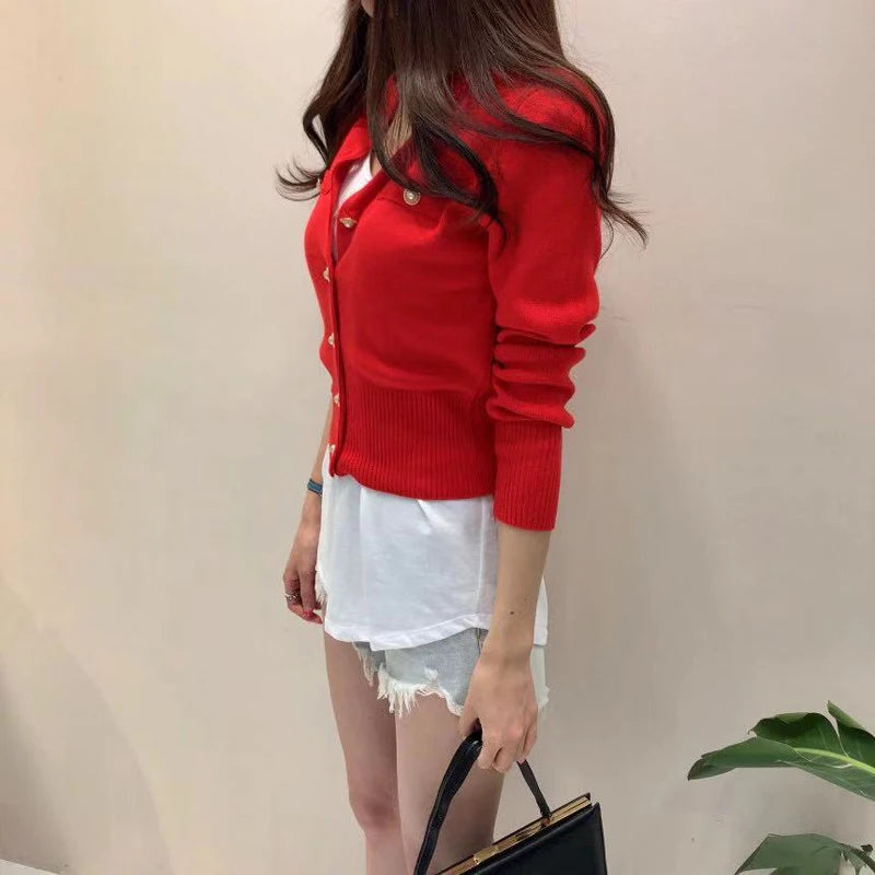 Women's knitted cardigan in red with gold button closure - long sleeve button-front sweater coat, side view styled with white shorts and handbag