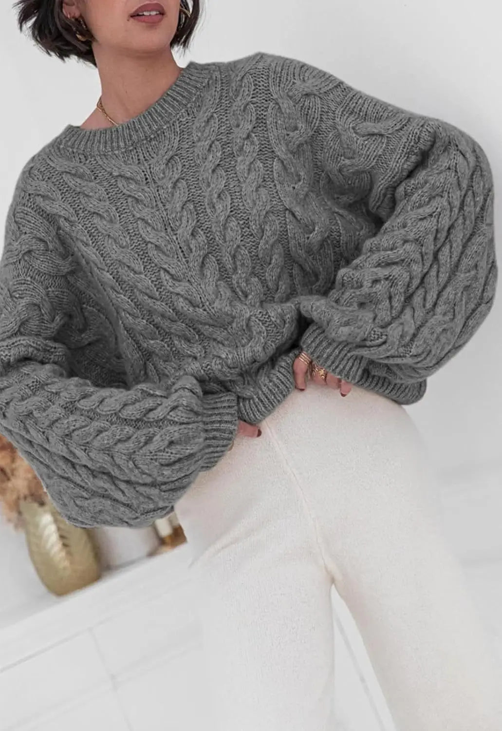 Women's loose fit O-neck sweater in gray cable knit high elastic pullover - front view seated pose