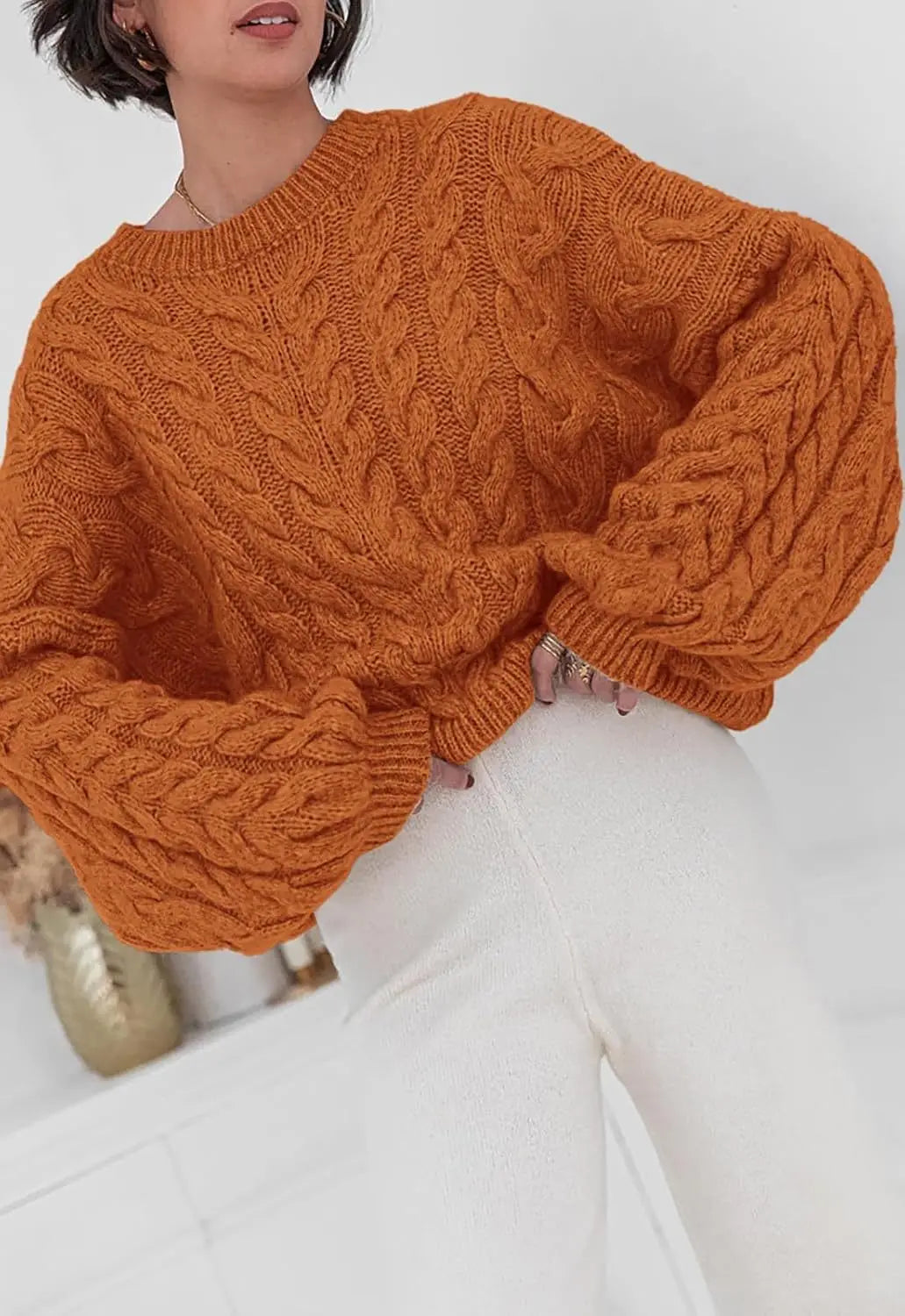 Women's loose fit O-neck sweater in orange cable knit high elastic pullover - front view with bag accessory