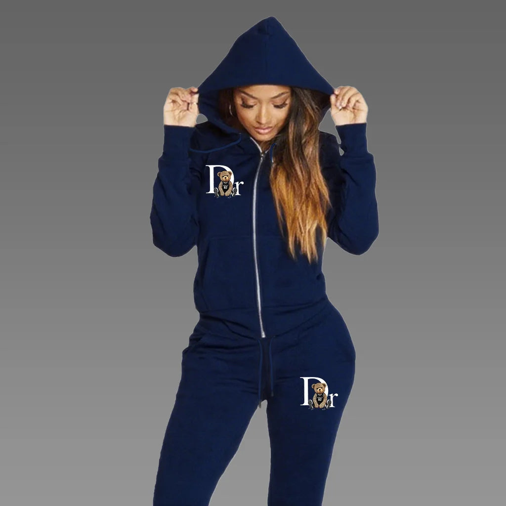 Woman wearing navy blue zip-up hoodie tracksuit set with matching sport pants, front view