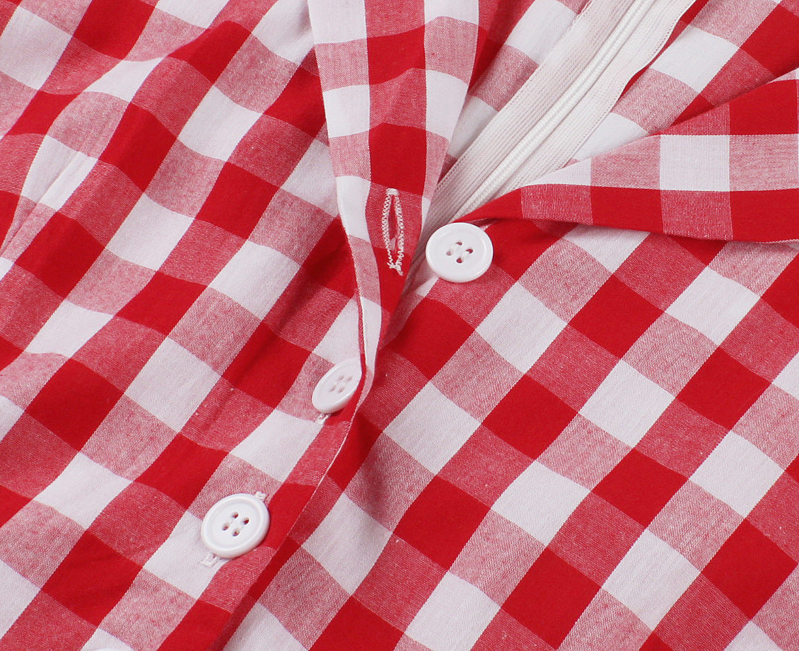 Close-up of red and white plaid fabric with white button detail on A-line dress
