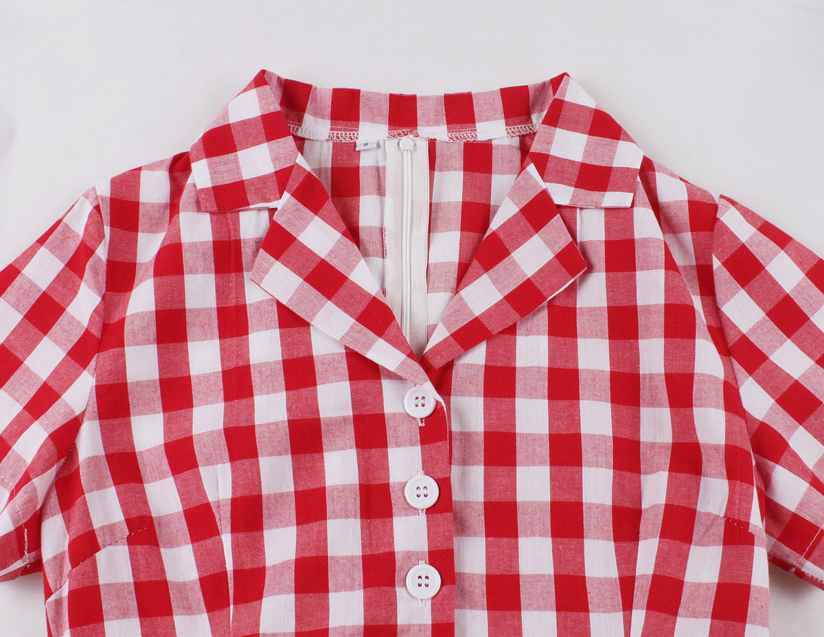 Close-up of red and white plaid dress suit collar with buttons and zipper back detail