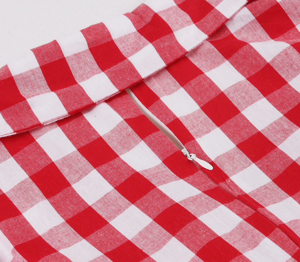 Close-up of back zipper closure on red and white plaid A-line dress