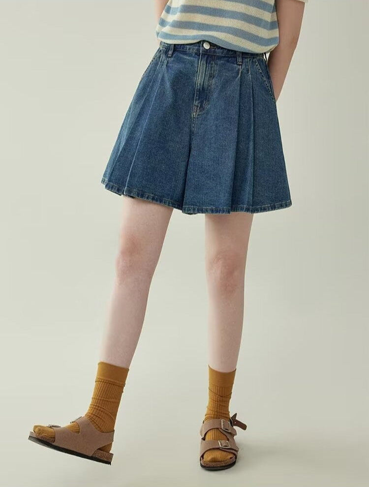 Women's wide leg pleated denim culottes in blue, back view styled on model