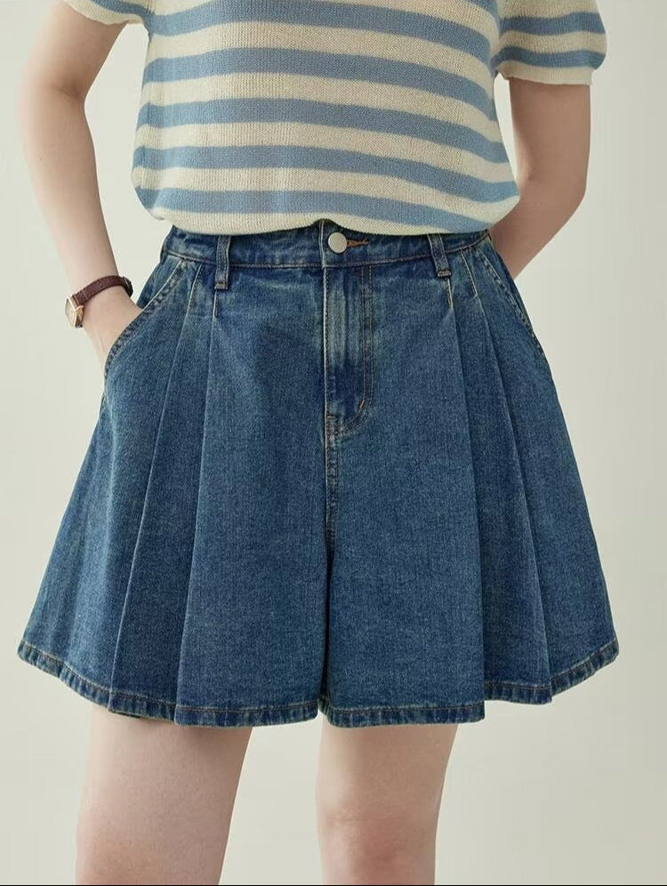 Women's wide leg pleated denim culottes in blue, front view styled on model