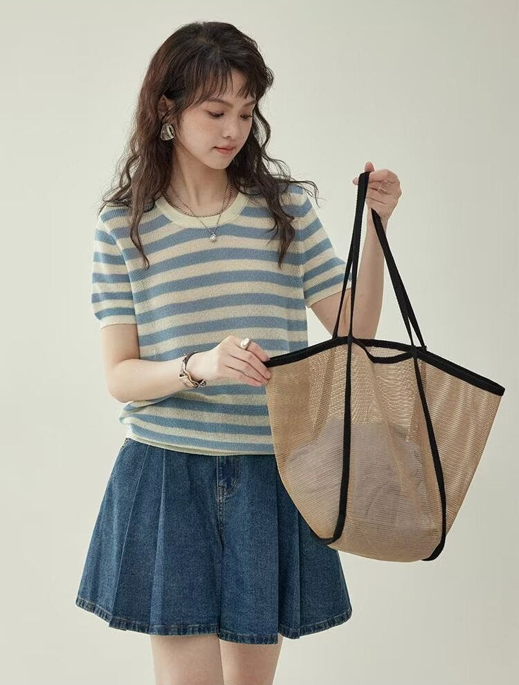 Women's wide leg pleated denim culottes in blue, full body front view styled on model with bag