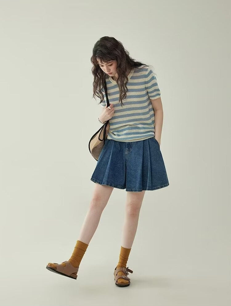 Women's wide leg pleated denim culottes in blue, full body front view styled on model looking down