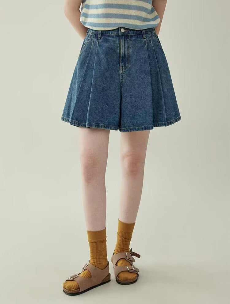 Women's wide leg pleated denim culottes in blue, full length view styled on model