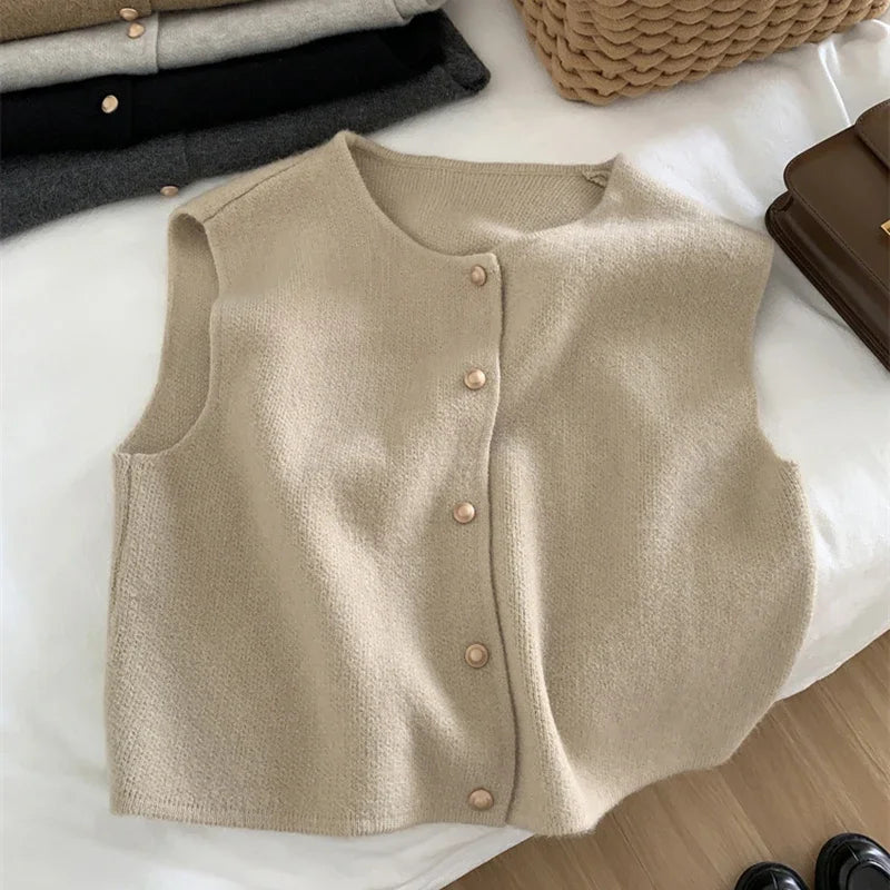 Women's sleeveless knit cardigan with O-neck and button closure, beige, front view