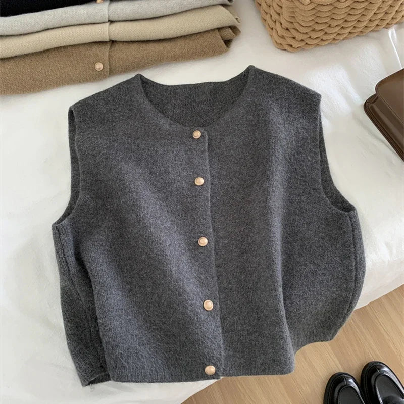 Women's sleeveless knit cardigan with O-neck and button closure, dark gray, front view