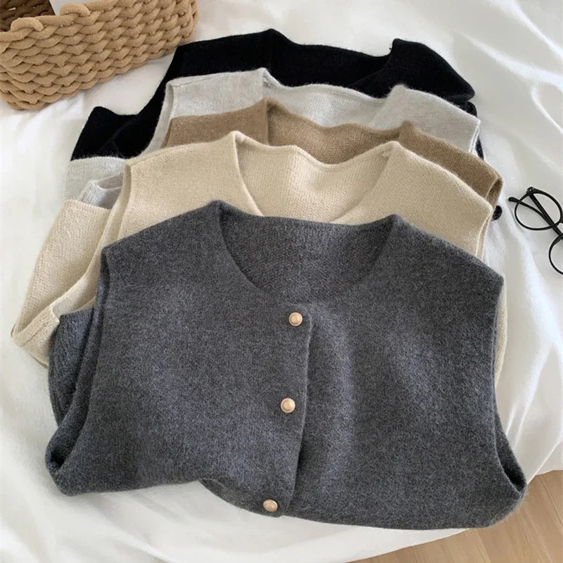 Women's sleeveless knit cardigan with O-neck and button closure, multiple colors, flat lay